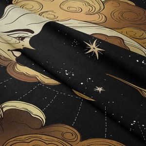 Macro detail of sun and moon tapestry fabric showing soft velvet texture and gold printing