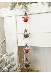 Detail of felt Christmas gnomes on a rope ladder hanging on a festive white fireplace