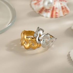 Minimalist geometric hollow gold and silver chain rings on natural beach decor