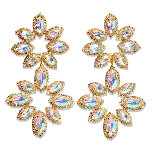 Detailed macro view of gold flower earrings with AB colorful marquise rhinestones