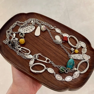 Detail of bohemian layered necklace with colorful ceramic beads in a wooden tray