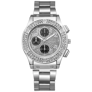 Close-up of luxury silver quartz watch with diamond bezel and chronograph dials