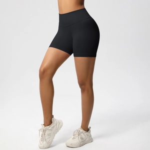 Close-up of high-waist seamless black athletic shorts with peach lift effect for fitness