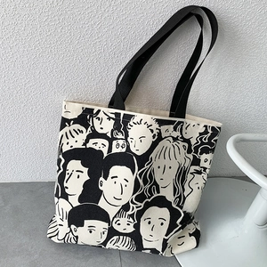 Artistic canvas tote bag featuring black line-art character faces and durable black straps