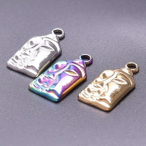 Detailed view of rectangular 18k gold and rainbow face pendants with metal relief