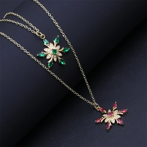Gold snowflake pendant necklace set with green and pink micro-set cubic zirconia crystals
