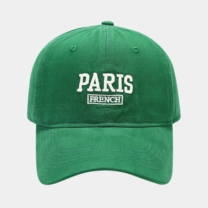 Detailed embroidery of PARIS FRENCH text on dark green cotton baseball cap crown