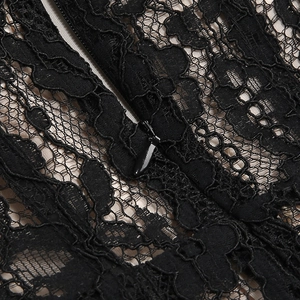 Macro view of black floral lace fabric with hidden zipper detail on formal dress