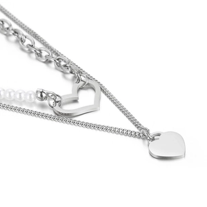 Double-layered stainless steel necklace with silver heart pendants and white pearls