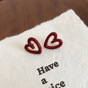 Minimalist deep red hollow heart stud earrings with a glossy enamel finish and silver pins