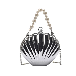 Elegant silver shell clutch bag with pearl handle and metallic chain strap