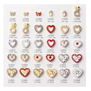 Macro view of 30 assorted mini nail art charms with heart and bow designs in alloy