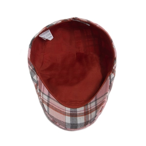 Pink and grey herringbone check flat cap showing interior lining and care label