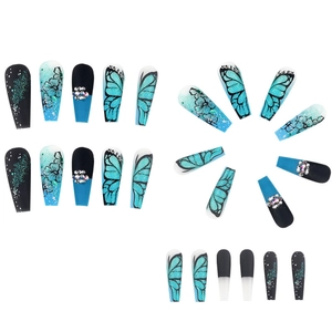 Detail view of long press-on nails with butterfly wings, flowers and rhinestones