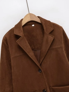 Detail of a brown faux suede blazer showing the notch lapel and fine fabric texture