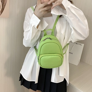 Lime green mini faux leather backpack for women with round handle and adjustable straps
