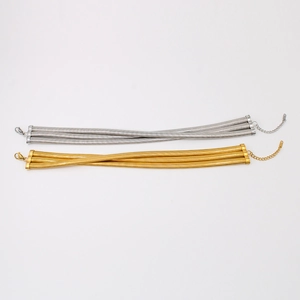Detail of three-layer gold and silver snake bone chain necklaces with lobster clasps