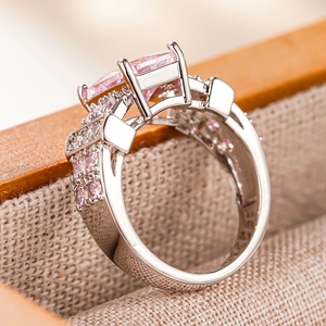 Macro detail of silver square ring with pink rectangle gemstone and micro-paved crystals