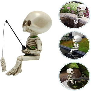 Detailed view of miniature skeleton figurine fishing with moss accents on white background