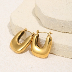 Minimalist 18K gold plated stainless steel U-shaped hoop earrings on stone display