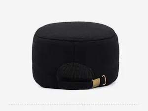 Detail of adjustable back strap and vintage bronze buckle on a black wool cadet cap
