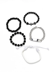 Detail of 5-piece multilayer bracelet set with black beads, silver chain, and woven rope