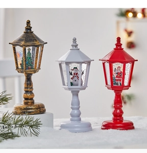 Three vintage Christmas lanterns with Santa, snowman and tree scenes in fake snow