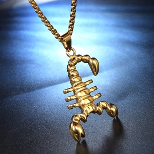 Detailed macro shot of a 3D gold scorpion pendant necklace with polished finish