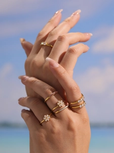 Detailed stack of 18k gold plated adjustable rings with zircons and floral designs