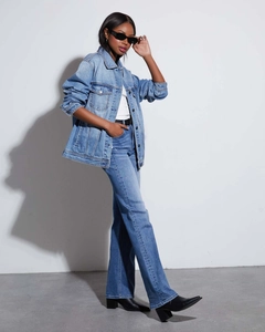 Side view of oversized washed blue denim jacket and matching high-waisted jeans for women