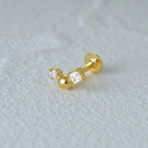 Macro view of gold flat back cartilage stud with round and square cubic zirconia gems