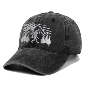 Detailed white embroidery of Bigfoot with mountains on washed vintage baseball cap