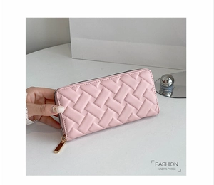 Detail of pink PU leather long wallet featuring woven embossing and gold zipper closure