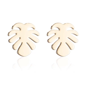 Close-up of golden monstera leaf stud earrings with polished finish and soft reflection