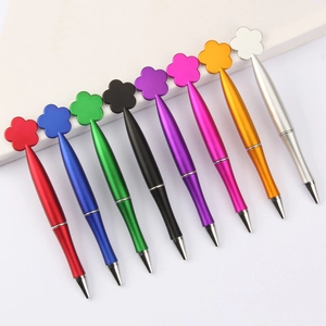 Set of eight metallic ballpoint pens with flower-shaped caps in assorted vibrant colors