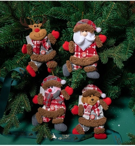 Close-up of four plush Christmas figurines hanging on a tree with wooden buttons
