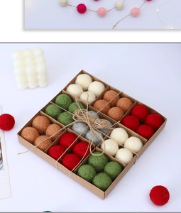 Close-up of colorful 3cm wool felt balls in a kraft gift box with a rustic jute bow