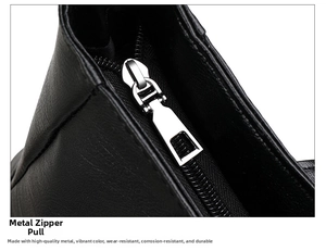 Macro detail of high-quality silver metal zipper head on textured black leather tote bag