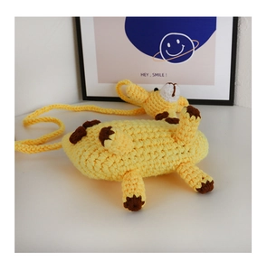 Detailed macro view of a handmade yellow crochet giraffe crossbody bag for kids