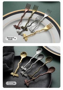 Macro view of vintage dessert fork and spoon featuring dragonfly handle detail