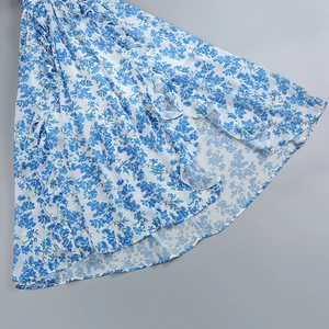 Close-up of floral dress hemline featuring elegant ruffles and layered chiffon fabric texture
