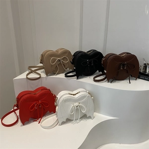 Bat wing heart-shaped crossbody bags in five colors with unique lace-up details