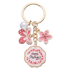 Detailed shot of pink enamel butterfly keychain with flower, pearl, and Mother's Day charm