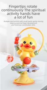 Close-up of yellow duck suction spinner toy with colorful beads for baby motor skills
