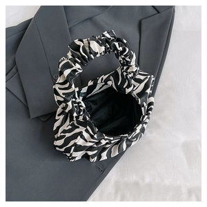 Detailed view of cloud shape handbag featuring black and white zebra pattern print