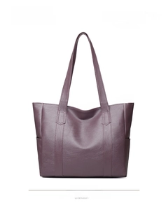 Detail view of large purple tote bag with litchi grain texture and long shoulder straps