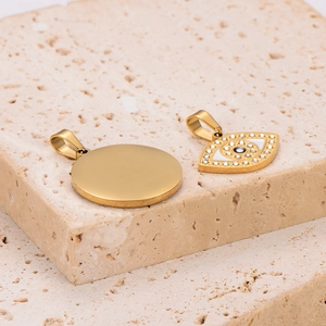Pendentif œil du mal en acier doré avec diamants sur fond de pierre naturelle