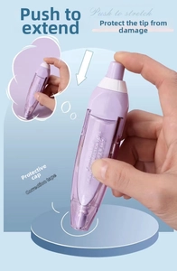 Detail of purple retractable correction tape showing 6M refill and push mechanism