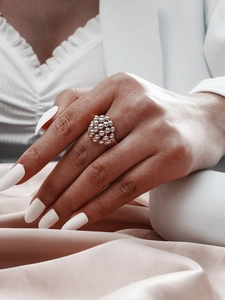 Macro shot of silver ball cluster open ring with smooth metallic beads on a slender band