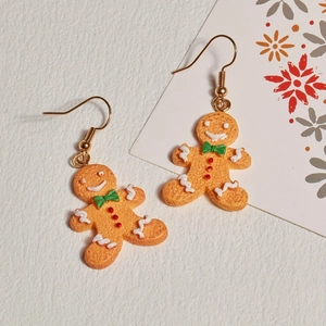 Cute gingerbread man Christmas earrings with white frosting and green bow tie details